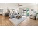Open concept living room flows into the kitchen, featuring wood floors, modern decor, and natural light at 2014 Anna Lilley Dr, Fuquay Varina, NC 27526