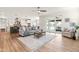 Open living space with hardwood floors connecting the living room, kitchen, and outdoor patio at 2014 Anna Lilley Dr, Fuquay Varina, NC 27526