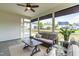 Relaxing sunroom featuring comfortable seating, ceiling fan and views of the backyard at 2014 Anna Lilley Dr, Fuquay Varina, NC 27526