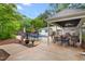 Spacious backyard features a pool, outdoor kitchen, covered seating area, and manicured landscaping at 204 Random Ln, Burlington, NC 27215