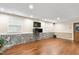 Finished basement with hardwood floors, stone accents, and walkout exit at 204 Random Ln, Burlington, NC 27215