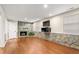 Finished basement featuring hardwood floors, stone fireplace, and TV at 204 Random Ln, Burlington, NC 27215