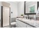 Bathroom vanity featuring granite countertops, white cabinets, and a shower at 204 Random Ln, Burlington, NC 27215