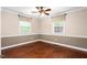 Bedroom featuring hardwood floors, chair rail, ceiling fan, and window at 204 Random Ln, Burlington, NC 27215