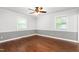 Bedroom featuring hardwood floors, two-toned paint, and natural light from windows at 204 Random Ln, Burlington, NC 27215