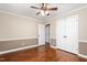 Bedroom featuring hardwood floors, chair rail, ceiling fan, and a closet at 204 Random Ln, Burlington, NC 27215