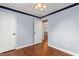 Bedroom featuring hardwood floors and a ceiling fan with a view to another room at 204 Random Ln, Burlington, NC 27215