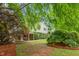 Beautiful two-story home with lush landscaping, mature trees, and well-maintained lawn at 204 Random Ln, Burlington, NC 27215