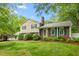 Charming two-story home featuring a brick facade, green shutters, and a well-manicured lawn at 204 Random Ln, Burlington, NC 27215