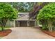 Charming two-story home featuring mature landscaping and a covered carport at 204 Random Ln, Burlington, NC 27215