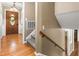 Foyer featuring hardwood floors, stairs with wood banister, and front door at 204 Random Ln, Burlington, NC 27215