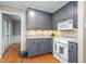 Well-equipped kitchen with gray cabinets, tiled backsplash, and modern appliances at 204 Random Ln, Burlington, NC 27215