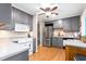 Modern kitchen with gray cabinets, stainless steel appliances, and eat-in breakfast area at 204 Random Ln, Burlington, NC 27215
