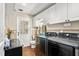 Modern laundry room with new appliances, ample cabinet space, and outdoor access at 204 Random Ln, Burlington, NC 27215