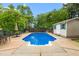 Inviting in-ground pool with a spacious concrete deck and surrounding lush greenery at 204 Random Ln, Burlington, NC 27215
