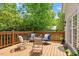 This wooden back deck offers an array of outdoor seating with views of mature trees at 216 N Bloodworth St, Raleigh, NC 27601