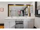 This bathroom offers a double vanity, framed mirror, and view of a glass shower and window at 216 N Bloodworth St, Raleigh, NC 27601