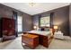 This bedroom features a dark grey wall, plush carpet, and a beautifully-lit chandelier at 216 N Bloodworth St, Raleigh, NC 27601