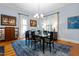 Formal dining room with hardwood floors, blue accent rug, and large windows at 216 N Bloodworth St, Raleigh, NC 27601