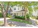 Charming two-story home with a welcoming front porch, well-manicured lawn, and mature trees providing shade at 216 N Bloodworth St, Raleigh, NC 27601