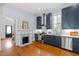Charming kitchen with stainless steel appliances, stylish cabinets, and a cozy fireplace, blending functionality and comfort at 216 N Bloodworth St, Raleigh, NC 27601