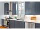 Charming kitchen features blue cabinets, stainless steel appliances, white countertops and backsplash at 216 N Bloodworth St, Raleigh, NC 27601