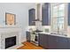 Bright kitchen with stainless steel appliances, marble countertops and custom cabinets and mantel at 216 N Bloodworth St, Raleigh, NC 27601