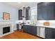 Modern kitchen with stainless steel appliances, shaker cabinets, and a cozy fireplace, blending functionality and style at 216 N Bloodworth St, Raleigh, NC 27601