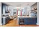 Modern kitchen island featuring a wine fridge, marble countertops, and stylish pendant lighting at 216 N Bloodworth St, Raleigh, NC 27601