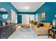 Comfortable living room with blue walls, a plush rug, and ample natural light, creating a relaxing atmosphere at 216 N Bloodworth St, Raleigh, NC 27601