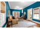 Bright living room with blue walls, wood floors, and white trim, complemented by a cozy couch at 216 N Bloodworth St, Raleigh, NC 27601