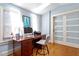 The home office has a classic desk, modern chair, and sunlit windows at 216 N Bloodworth St, Raleigh, NC 27601