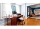 This home office with a classic desk looks out into a living room with abundant natural light at 216 N Bloodworth St, Raleigh, NC 27601