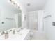 This all-white bathroom features a shower-tub combo and double sinks at 216 Ruby Walk Dr, Morrisville, NC 27560