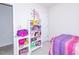 Bedroom with pink and purple bedding, white bookcase and built-in shelving at 216 Ruby Walk Dr, Morrisville, NC 27560