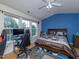 Bright bedroom with hardwood floors, large windows and contemporary decor offers a comfortable retreat at 216 Ruby Walk Dr, Morrisville, NC 27560