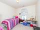Bright bedroom with a window, playful decor, and pink and purple bedding at 216 Ruby Walk Dr, Morrisville, NC 27560