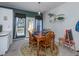 Charming dining area with a wooden table, four chairs, and access to the outdoor deck at 216 Ruby Walk Dr, Morrisville, NC 27560
