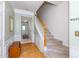 View of foyer and stairs showing hardwood floors, white wainscoting, and carpeted stairs at 216 Ruby Walk Dr, Morrisville, NC 27560