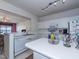 Bright kitchen features white cabinetry, modern appliances, and a functional center island with breakfast bar at 216 Ruby Walk Dr, Morrisville, NC 27560