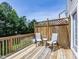 Cozy outdoor patio with wooden railing, chairs, and privacy fencing provides a relaxing retreat at 216 Ruby Walk Dr, Morrisville, NC 27560
