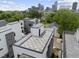 An aerial view of a building featuring a rooftop deck and city skyline at 221 Woodsborough Pl, Raleigh, NC 27601