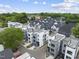 An aerial view of modern townhomes with sleek exteriors, complemented by well-manicured lawns and lush landscaping at 221 Woodsborough Pl, Raleigh, NC 27601