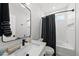 Modern bathroom featuring white fixtures, a sleek mirror, and ample storage at 221 Woodsborough Pl, Raleigh, NC 27601