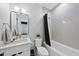 Bathroom featuring a vanity, commode, and tiled shower and tub with a curtain at 221 Woodsborough Pl, Raleigh, NC 27601