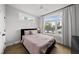 Cozy bedroom featuring large windows with views of the cityscape at 221 Woodsborough Pl, Raleigh, NC 27601