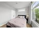 Well-lit bedroom showcasing hardwood floors, neutral walls, and modern windows at 221 Woodsborough Pl, Raleigh, NC 27601