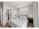 A calming bedroom features neutral tones, white bedding, and ample natural light at 221 Woodsborough Pl, Raleigh, NC 27601