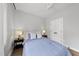 Cozy bedroom featuring a ceiling fan, two bedside tables, and a comfortable blue bed at 221 Woodsborough Pl, Raleigh, NC 27601