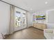 Modern bedroom with access to a balcony, hardwood floors, and plenty of natural light at 221 Woodsborough Pl, Raleigh, NC 27601